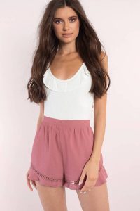 Shop the The Mary Ruffle Hem Shorts is a must have for the summer. Featuring a ruffle hem. Pair with Mary Off Shoulder Crop Top.