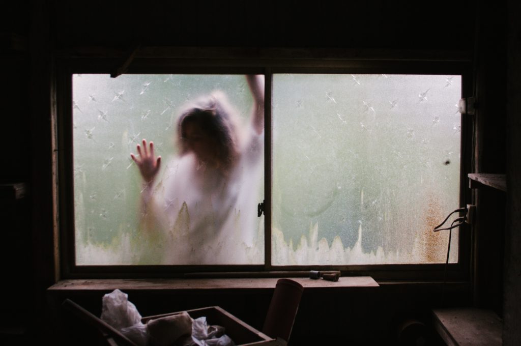 creepy woman in window by priscilla du preez