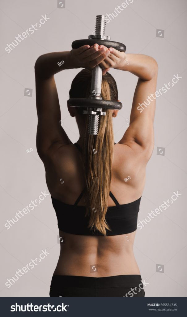 stock-photo-beautiful-young-woman-in-a-workout-gear-lifting-dumbbells-665554735