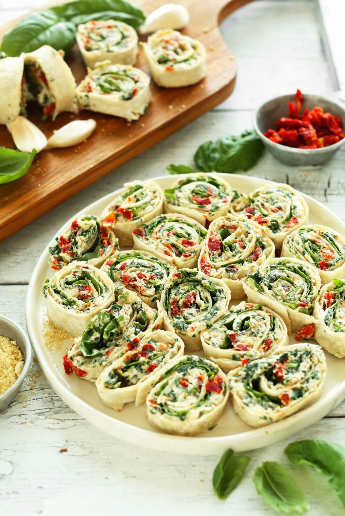 a plate of sun-dried tomato and basil pin wheels finger foods