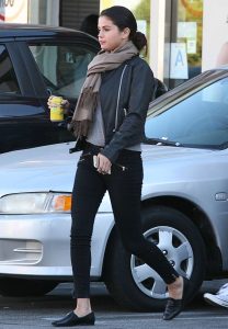 Selena Gomez steps out in a leather jacket and scarf.