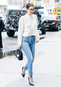 Bella Hadid steps out in a cropped sweater and jeans.