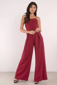 Stand out with our Mila Back Tie Jumpsuit. Featuring a straight neckline with back tie detail on a jumpsuit. Pair with simple heels and a clutch.