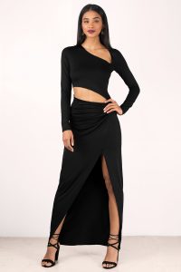 Designed by Tobi. You have to get your hands on the Kristopher Cut Out Maxi Dress. Featuring a front slit and cut outs. Pair the lace up heels and statement jewelry.