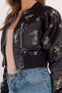 You're a wildflower in the Black Multi Jet Set Multi Floral Satin Cropped Bomber. Can you get any more romantic than smooth satin and floral print? We think not. This satin bomber jacket has stunning embroidered detail and thick ribbed cuffs, and oh did we mention that it’s cropped? Which means it’s absolutely perf with some high waisted jeans or a skirt for an eventful night out on the town.