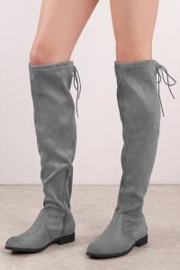 These faux suede knee high boots are the perfect staple for fall. Featuring a rounded toe and tie at back for the perfect fit.