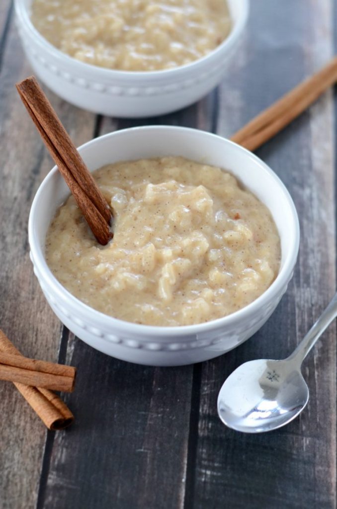 bowl of rice pudding with cinnamon stick