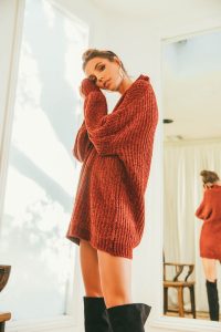 woman in sweater dress at home