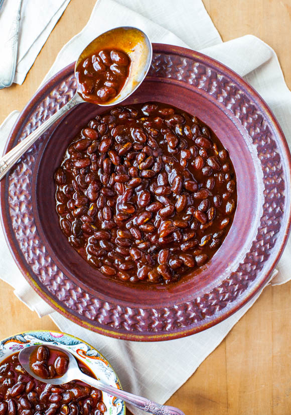 purple bowl of baked beans with spoon