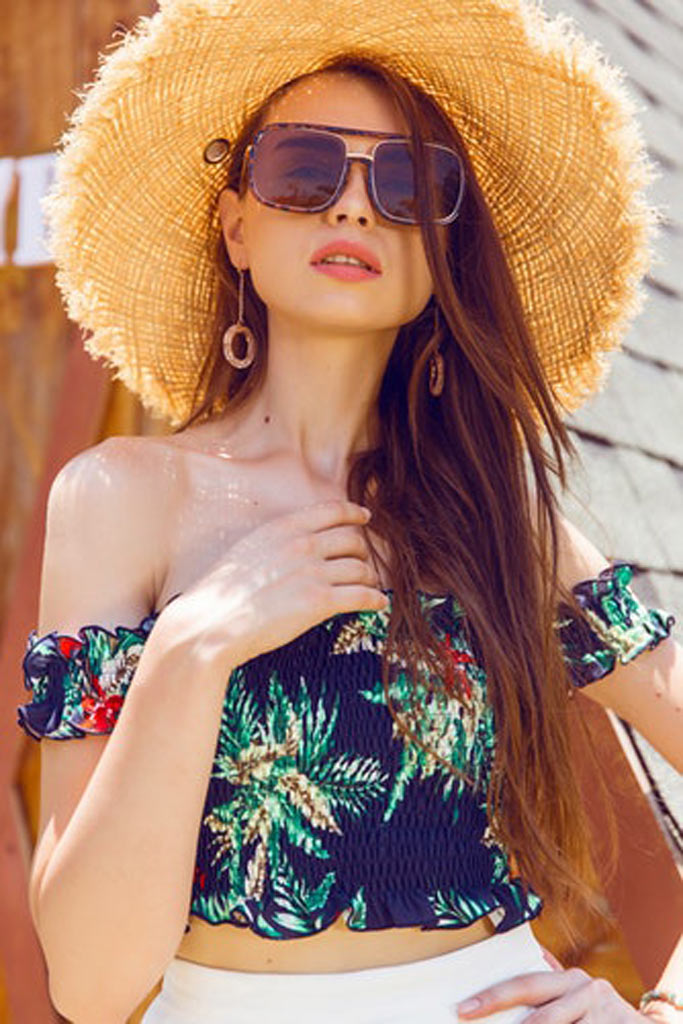 A woman wearing striking summer accessories to the beach